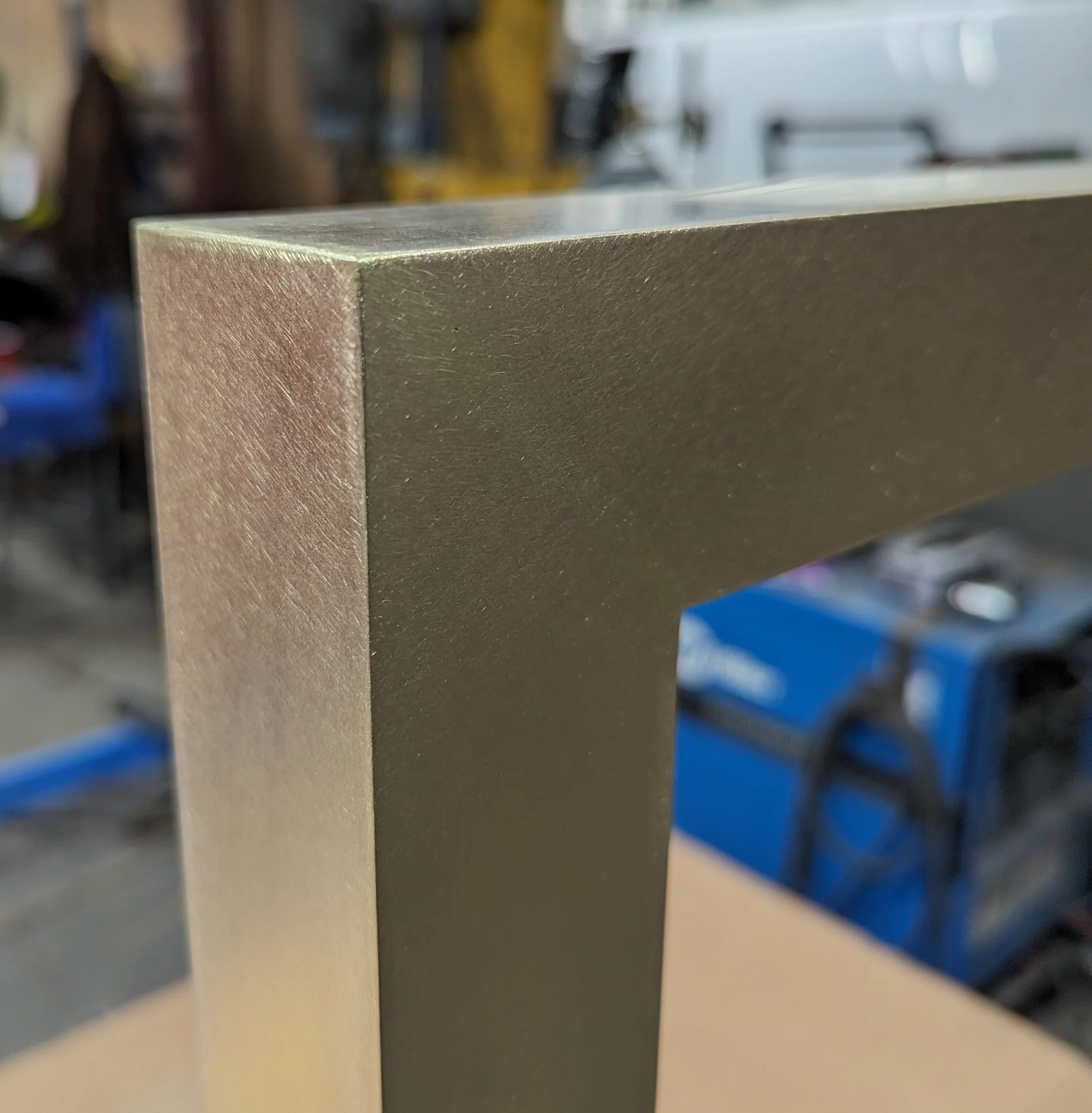 Close-up of a TIG welded brass corner joint with a 120 grit finish.
