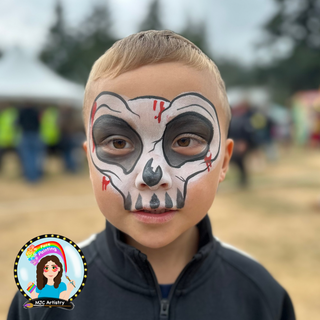 A young boy with face paint resembling a skeleton with black and red details at a public event in Vancouver. 