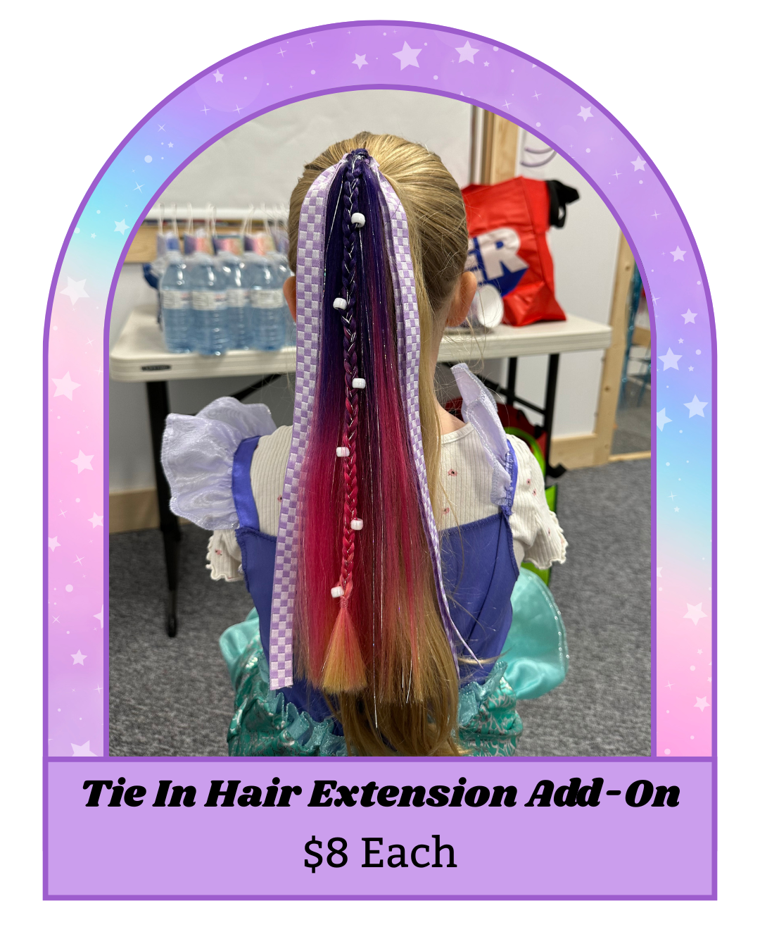 A young girl sitting with colorful hairstyle extensions tied in her hair, with a sign advertising "Tie In Hair Extension Add-On" for $8 each.
