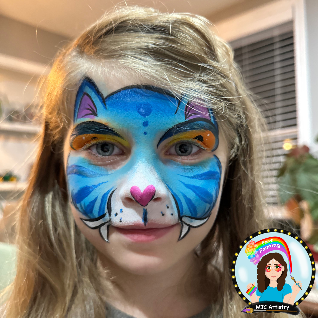 Child with a blue Depry the tiger from K pop demon hunters face paint at a birthday party in Vancouver. 