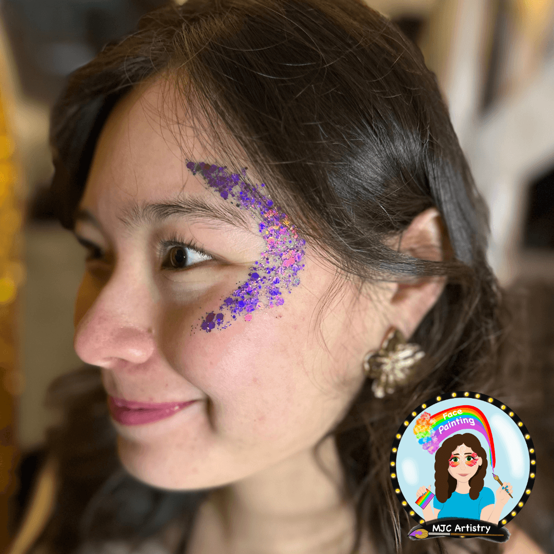 Woman wearing a purple crescent moon glitter design created at a glitter bar in Vancouver
