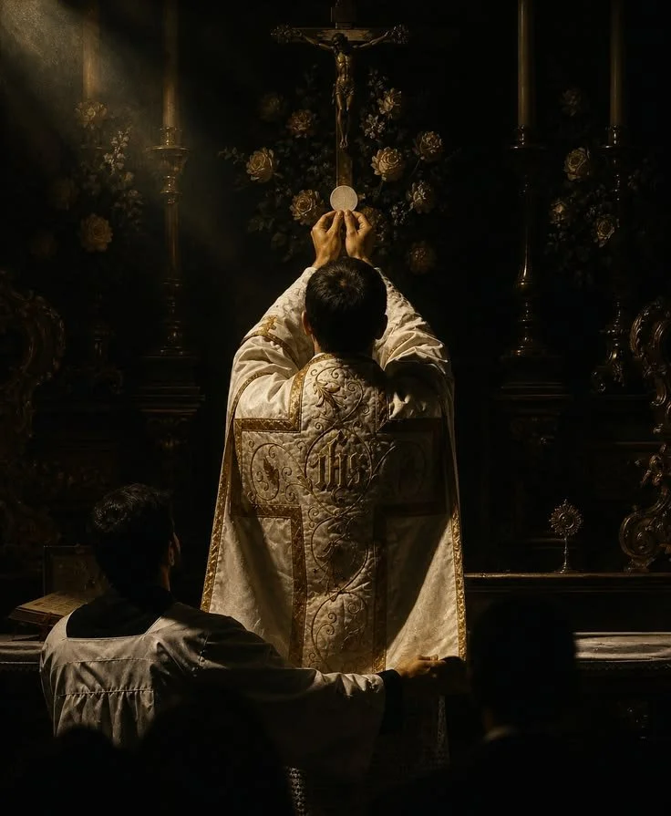A priest in ornate vestments holding a consecrated host during a religious ceremony in a dimly lit church, with a crucifix and flowers in the background.