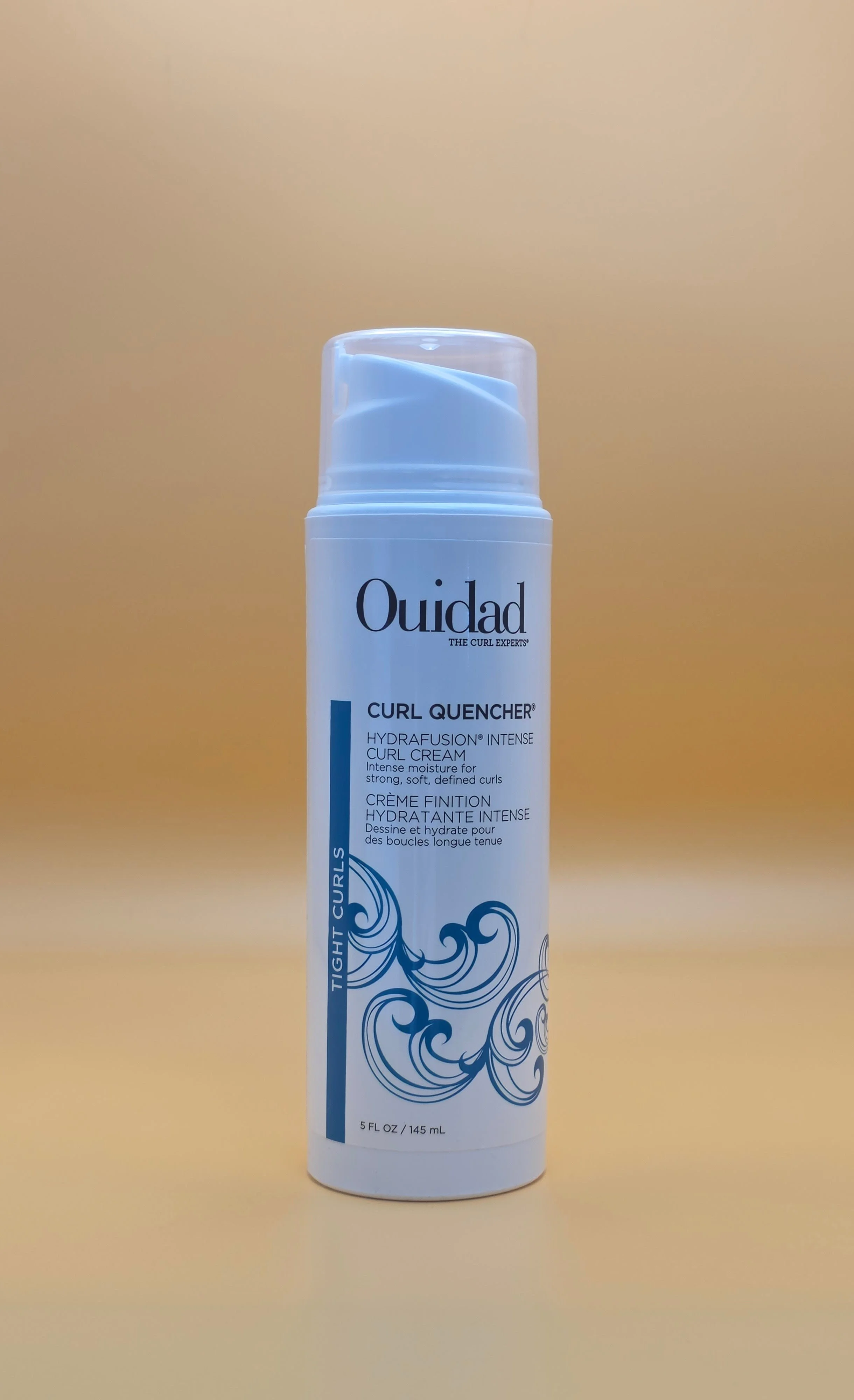 A white bottle of Ouidad Curl Quencher Hydrafusion intense curl cream with blue wave design on the label, set against a plain light background.