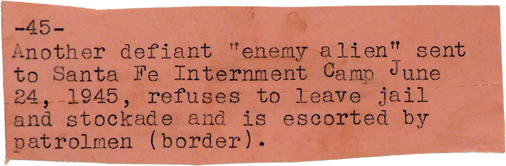 Typewritten note on pink paper about a suspected enemy alien sent to Santa Fe Internment Camp in June 1945 who refused to leave jail and was escorted by patrolmen at the border.
