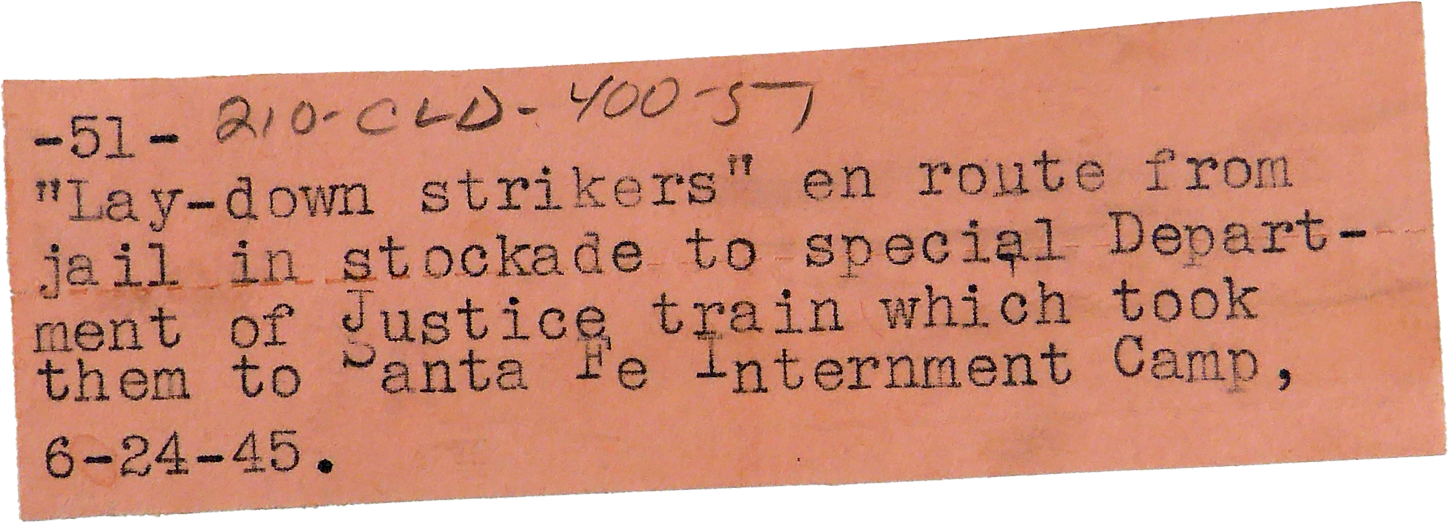 A handwritten note on a pink paper describing an event involving 'lay-down strikers' en route from a stockade to a detention camp, dated June 24, 1945.