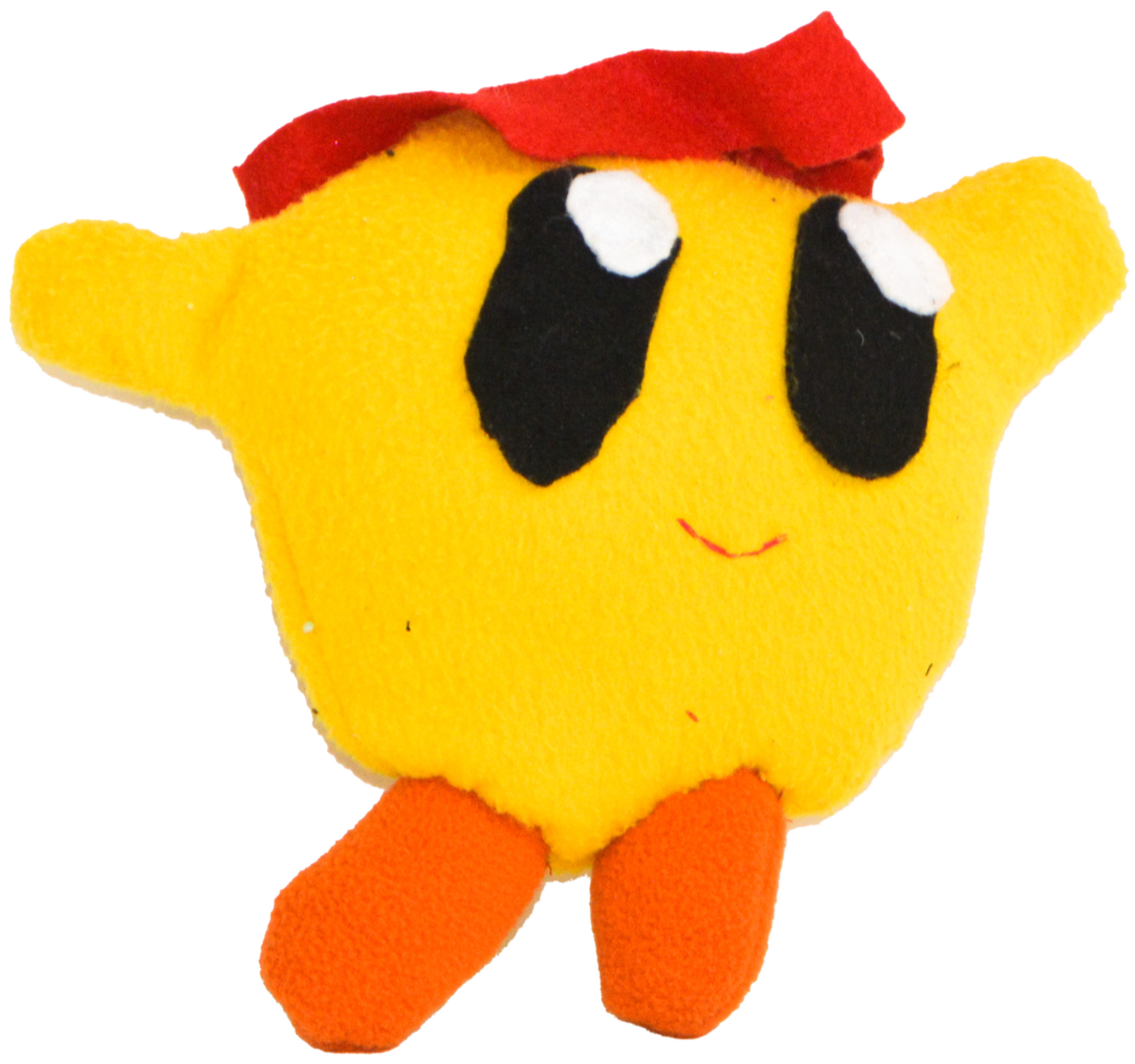 A plush yellow star-shaped toy with large black eyes, white reflections, a small red smile, orange feet, and red fabric on top.