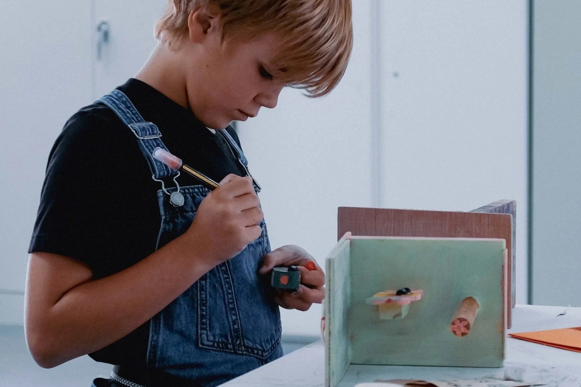 A young student working on his wood project at DesignX Summer Camp