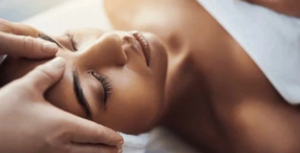 RMT thumbs on clients forehead