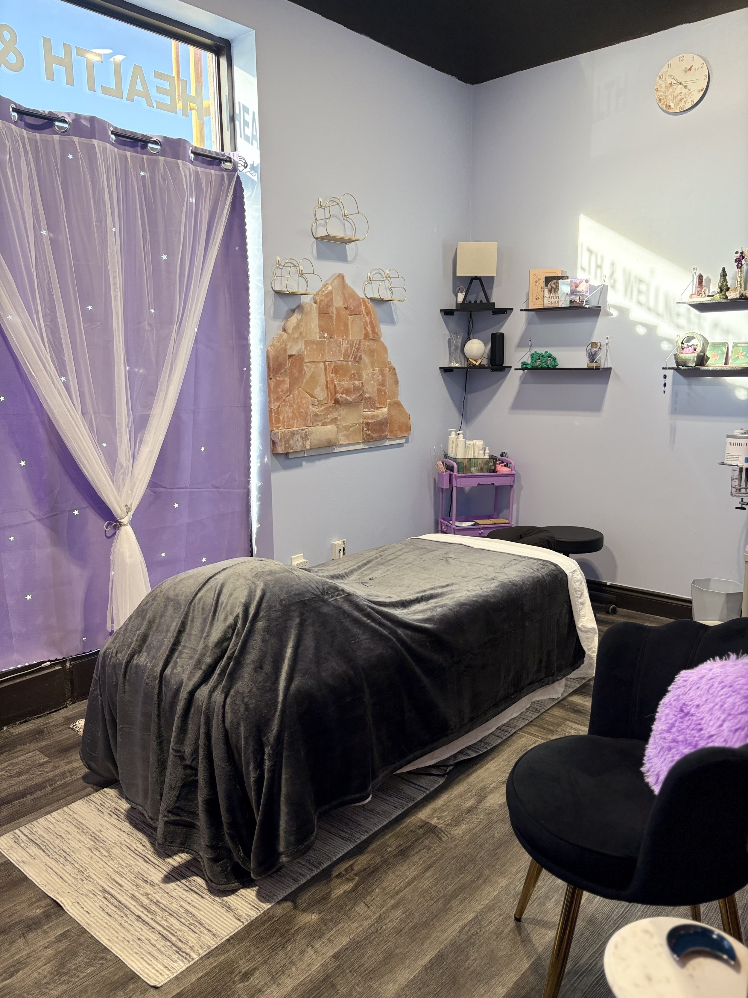 Spa room, massage table, salt, shelves and products