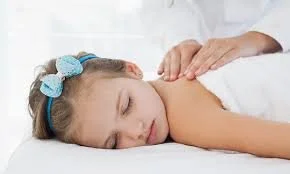 RMT hands on a child for youth massage