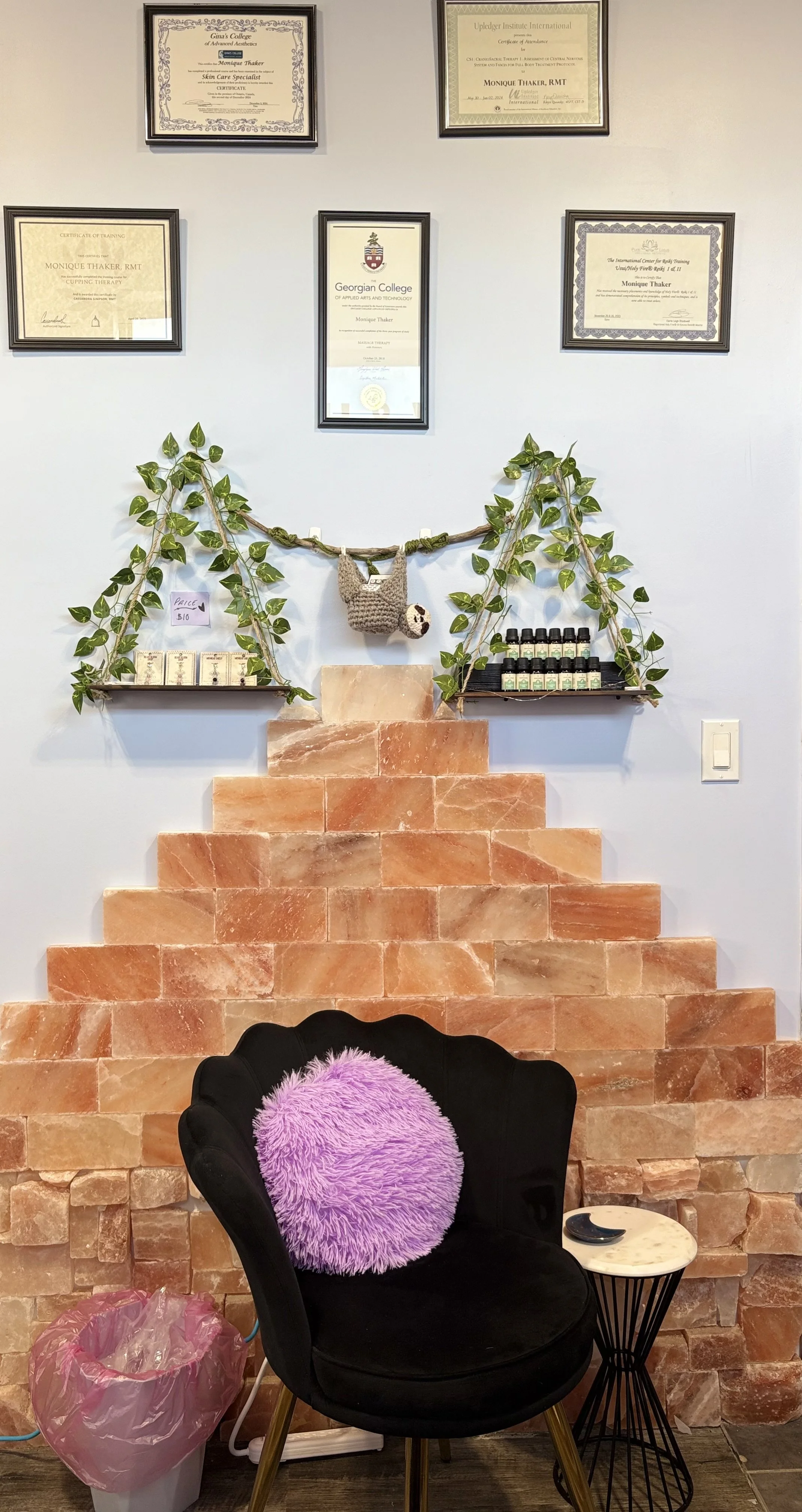 Part of the spa room, chair, oils, shelves with leaves and certificates