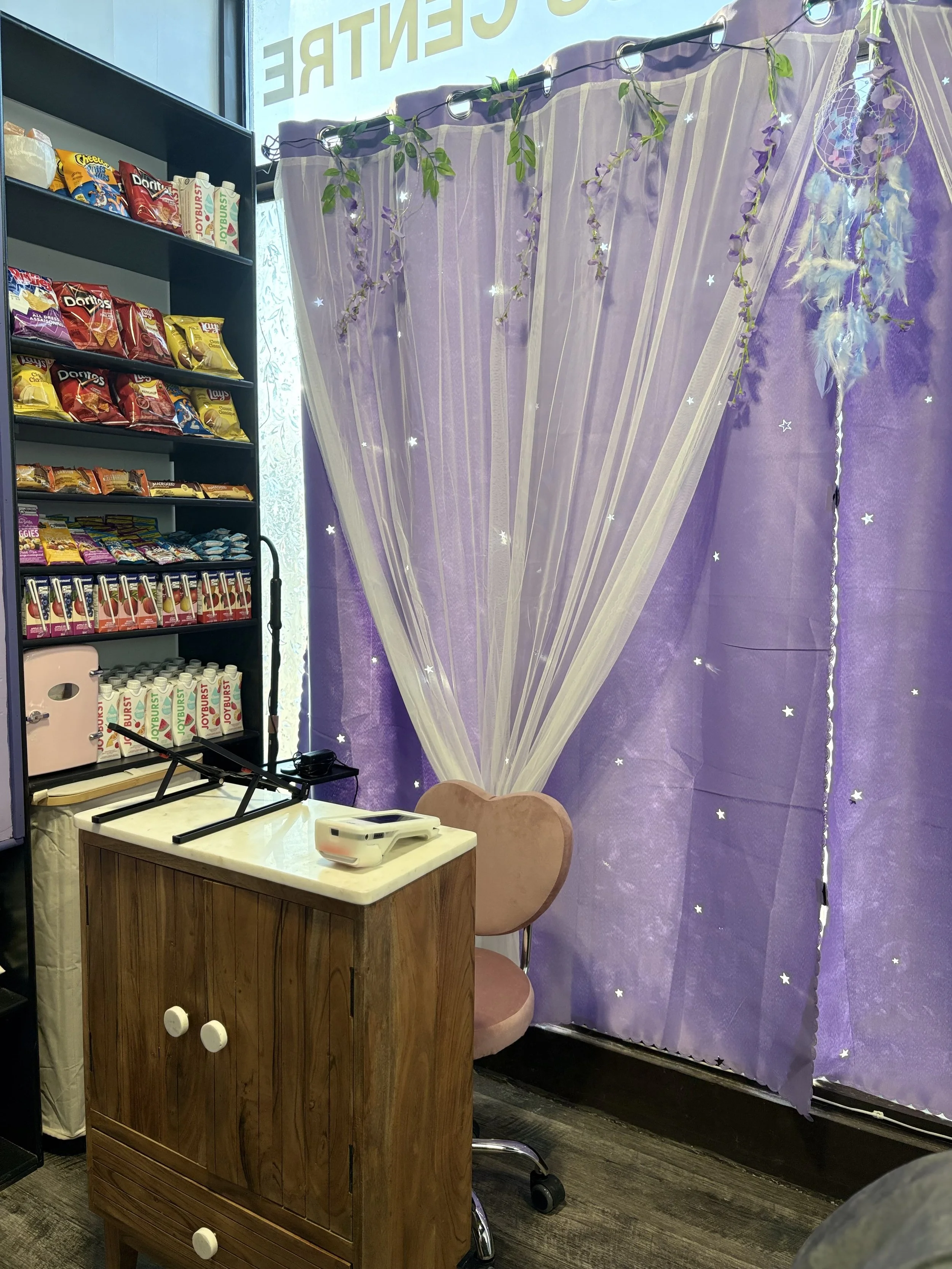 Purple curtains, desk, chair, snacks and drinks