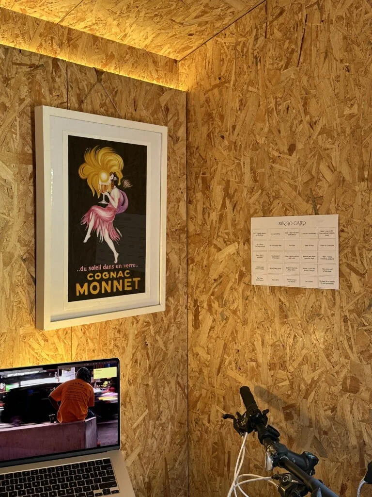 Photo of a room corner showing a laptop, art and new year bingo card on the wall