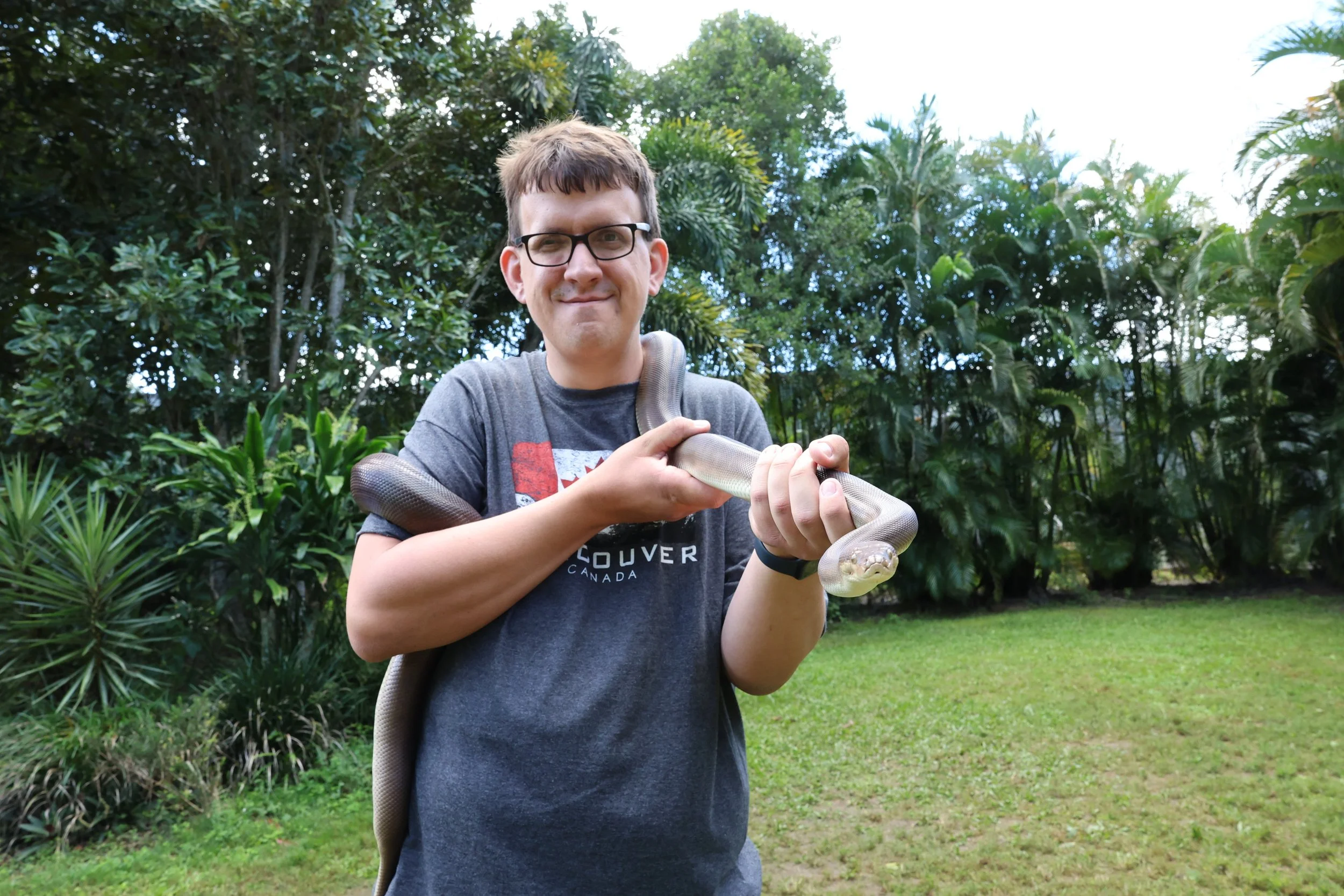 Nicholas Petersen holding a python at Australia Zoo