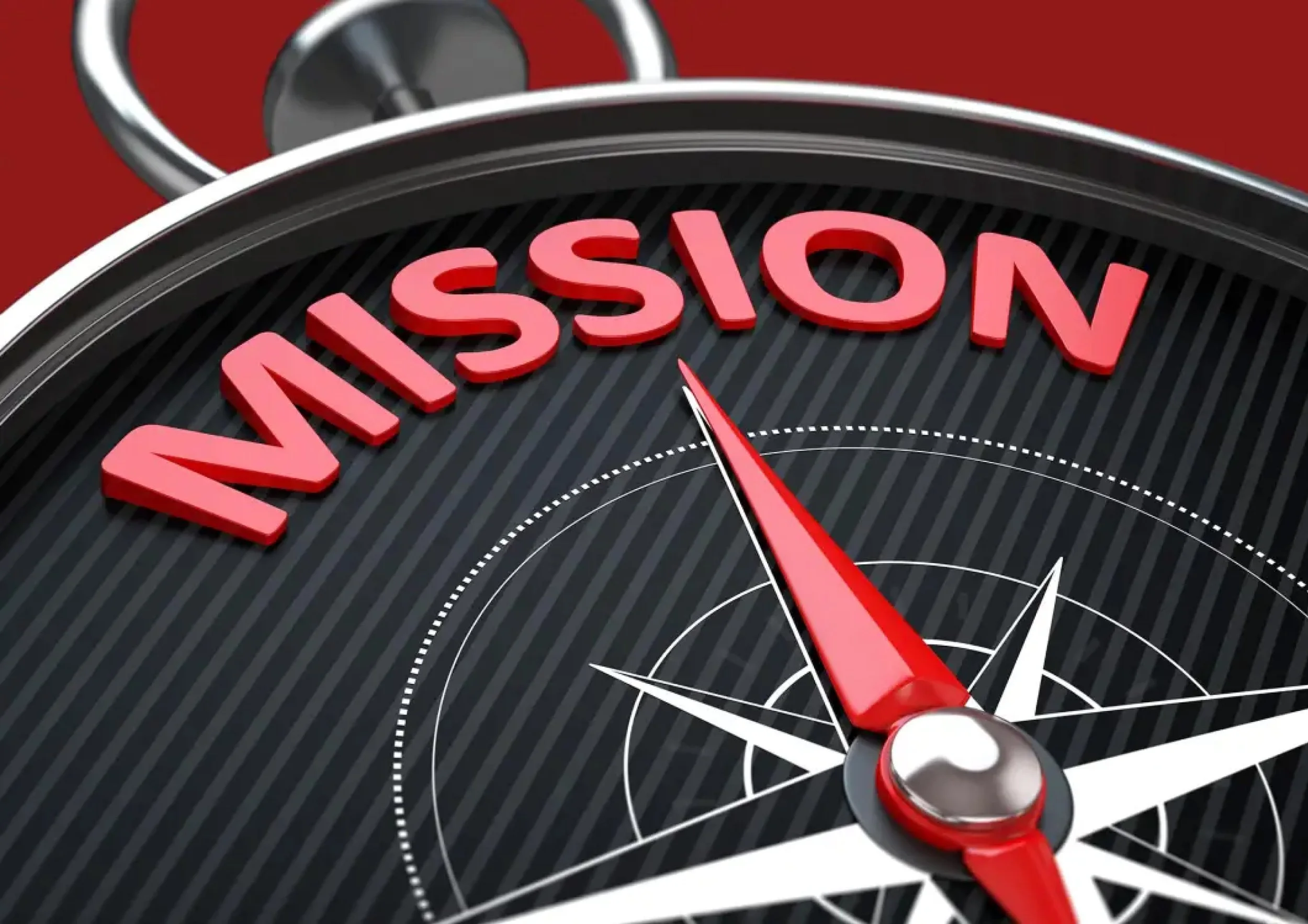 Close-up of a compass with the word 'MISSION' in large red 3D letters around it, pointing towards the word.