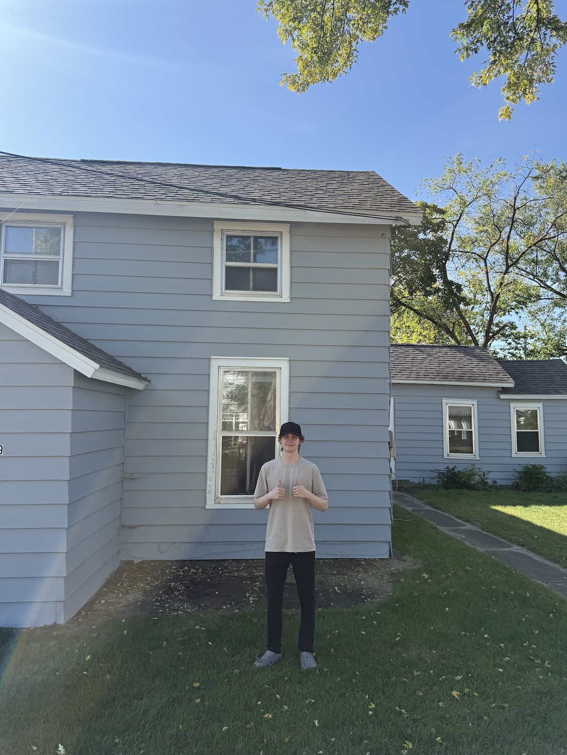 First-time home buyer standing in front of their new home in La Crosse, Wisconsin