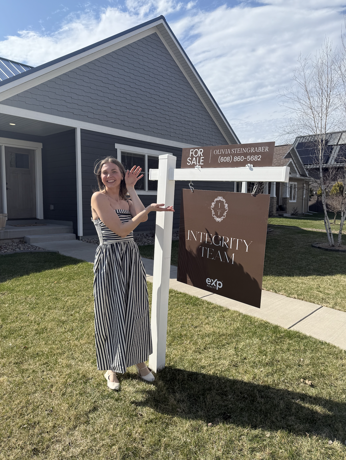 Olivia Steingraber standing in front of a home she sold as the listing agent