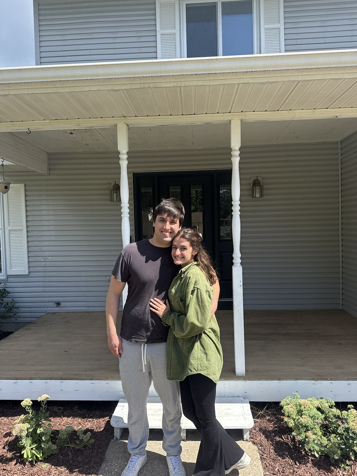 First-time home buyers in front of their new home after closing in La Crosse, Wisconsin