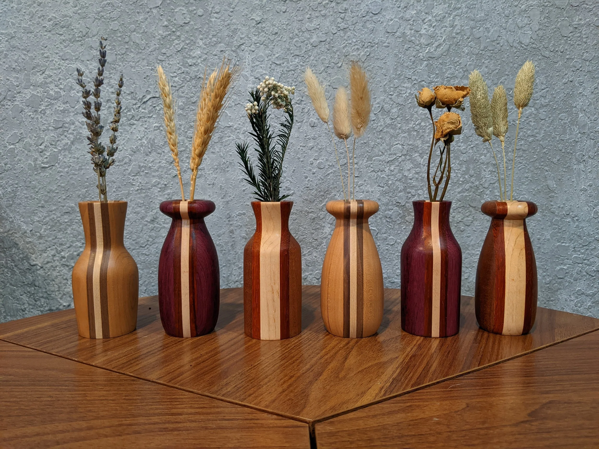 A variety of handcrafted wood twig vases made from assorted hardwoods
