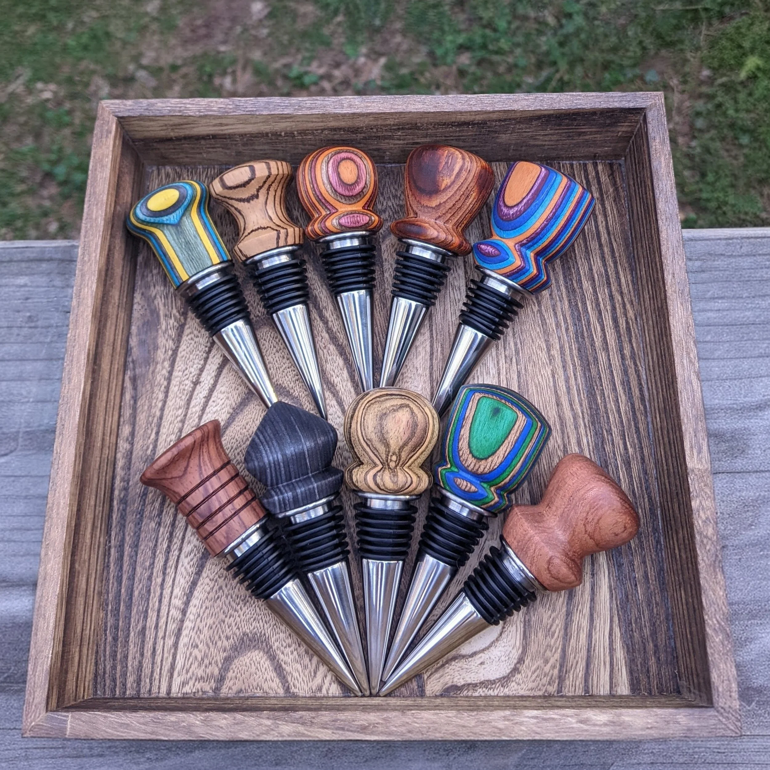 Tray holding handcrafted wood bottle stoppers