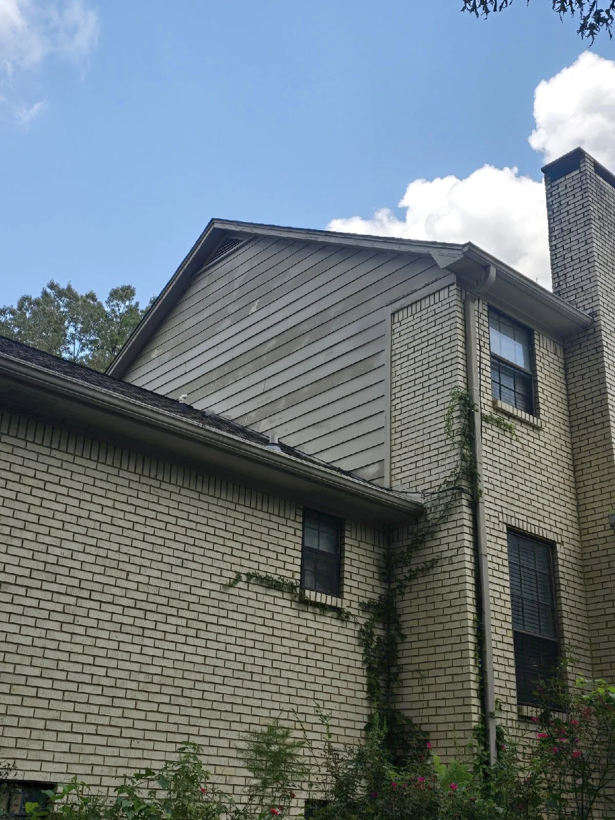 Over time, the siding, shutters, and windows had begun to show wear, the fence was damaged, and the existing deck no longer met their needs.