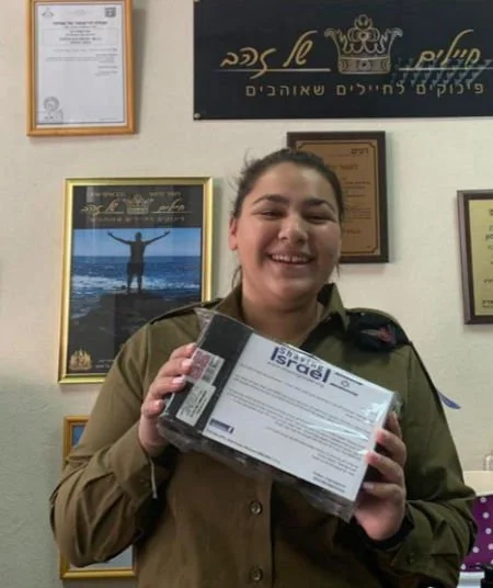 Female soldier holding certificate.jpg