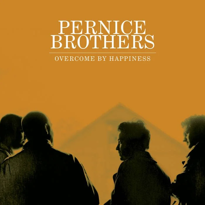 Silhouettes of four people standing outdoors with a house and orange sky in the background, related to the concept of the 'Pernice Brothers' band and their album 'Overcome by Happiness'.