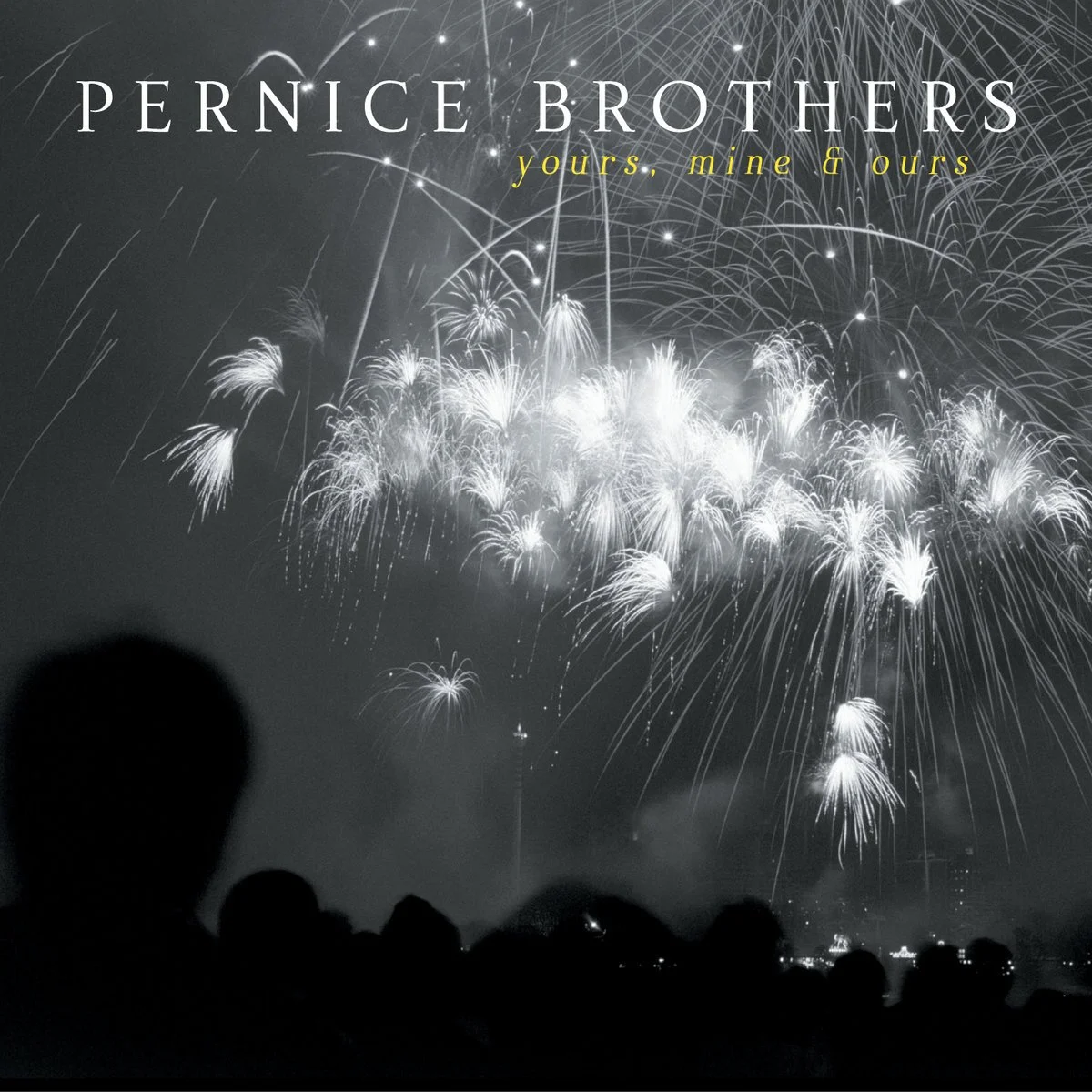 Black and white photo of fireworks lighting up the night sky with crowd silhouettes in the foreground, and the text "Pernice Brothers" and "yours, mine & ours" at the top.