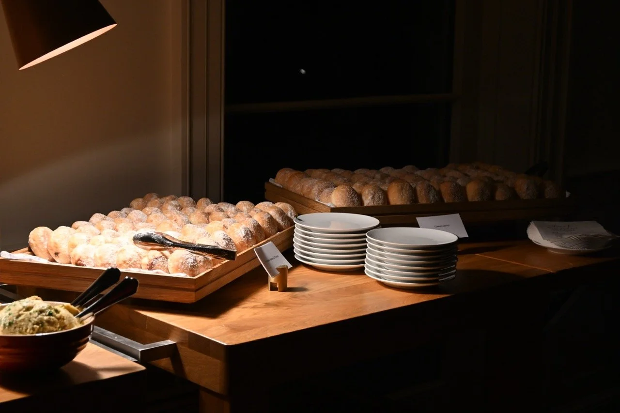 Rustic luxury dessert or roll display station set out for guests on a wooden table at a Charlottesville event.