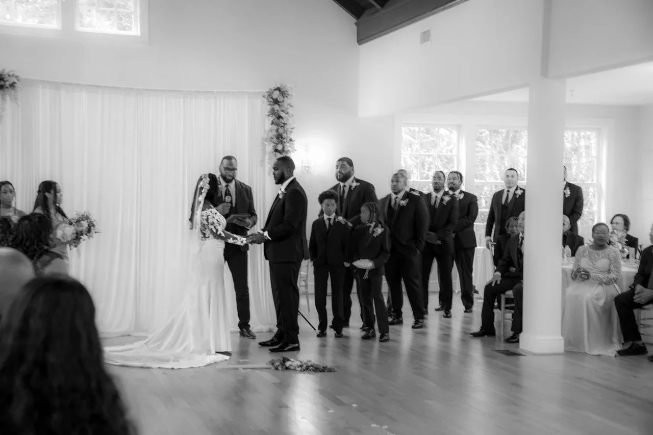 Kareese and Tristan exchanging wedding vows at the altar during a beautiful ceremony in Portsmouth, Virginia.