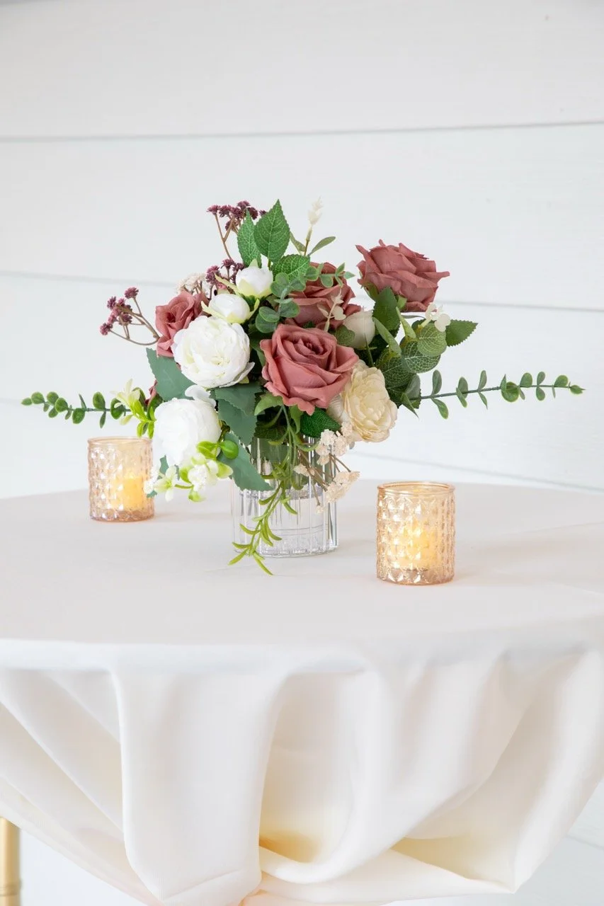 Blush and burgundy wedding floral centerpiece on a reception table at the Woman's Club of Portsmouth.