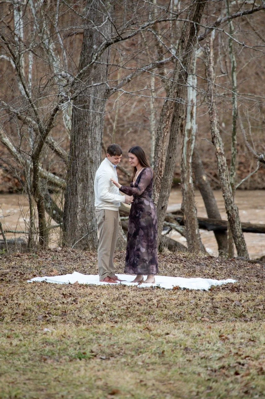 Caroline and Clay pouring glasses of champagne to celebrate their engagement in Richmond, VA.