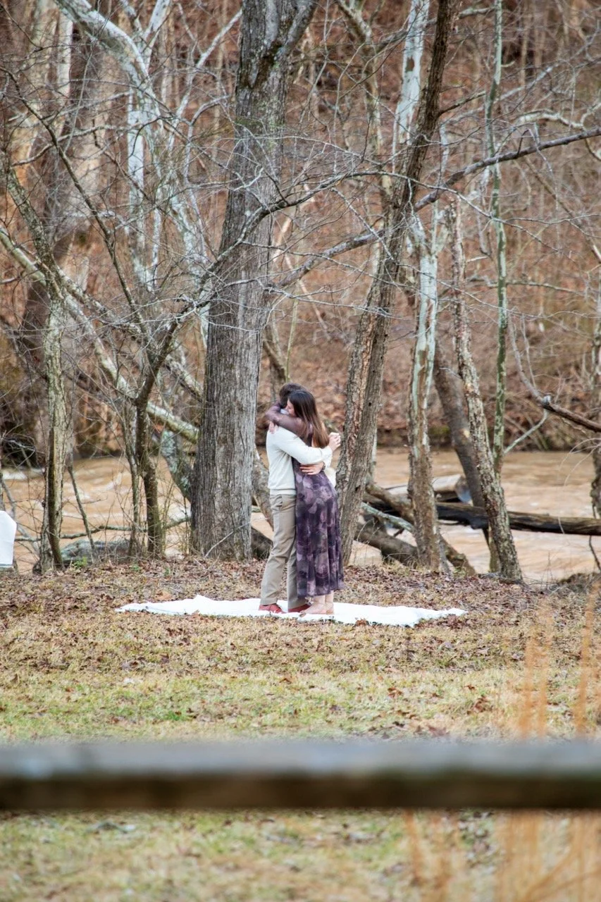 A beautiful distant view of a couple celebrating their new engagement on a private scenic estate in Virginia.