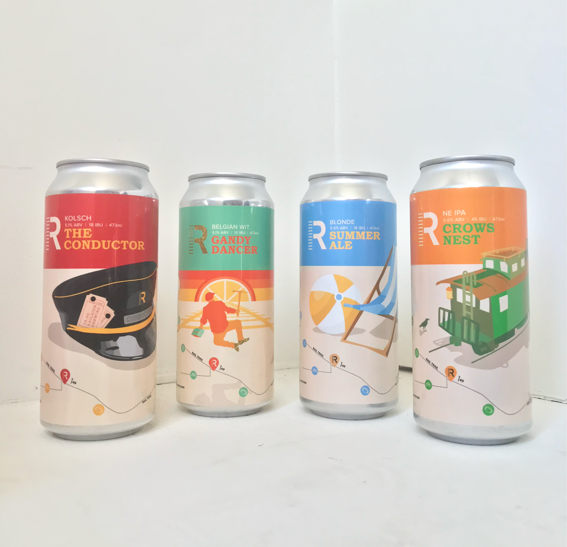 Four aluminum cans of beer with colorful illustrated labels, arranged in a row on a white surface against a white background.