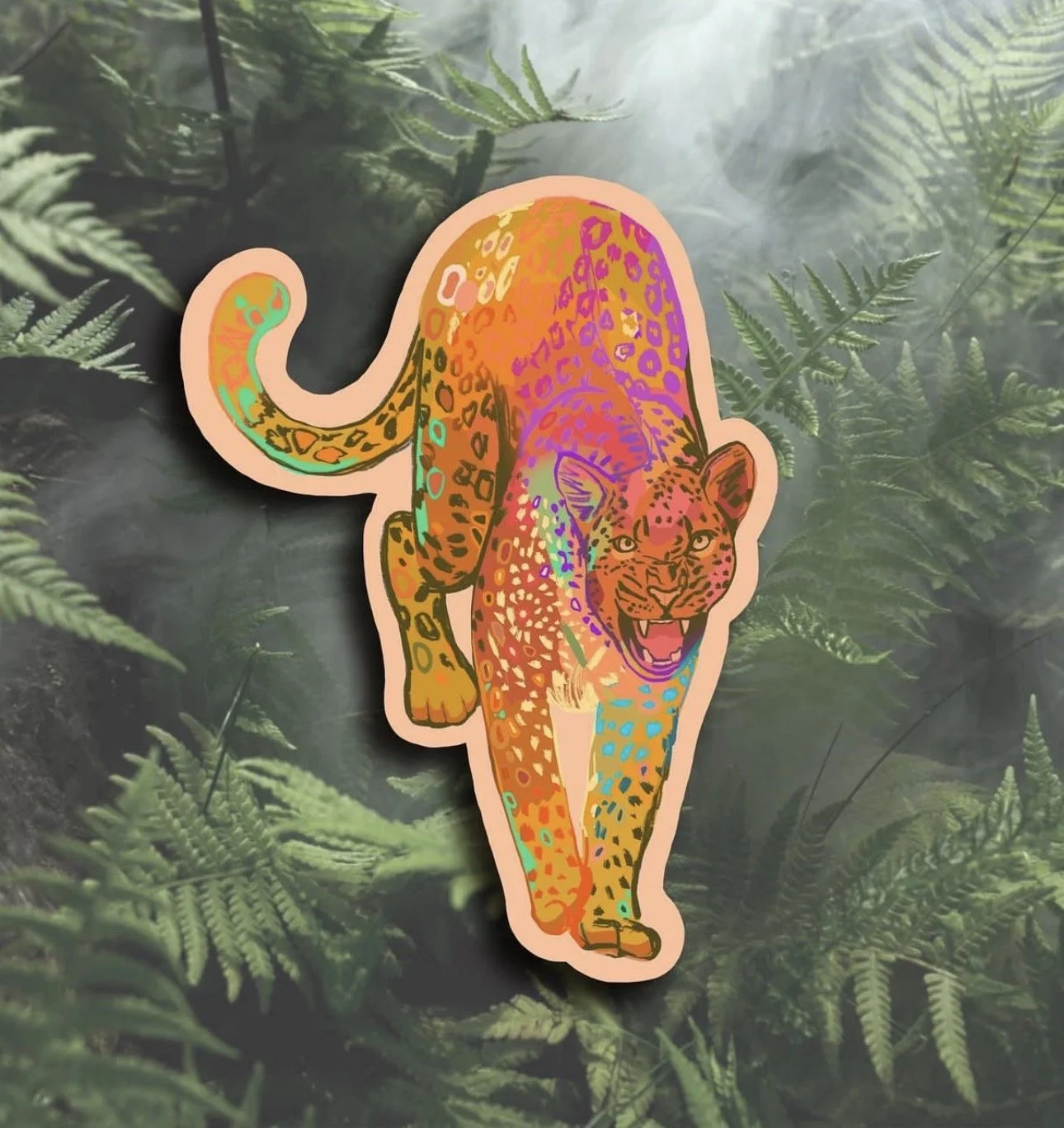 Colorful sticker of a puma or mountain lion with rainbow multicolor patterns on a leaf-filled background.
