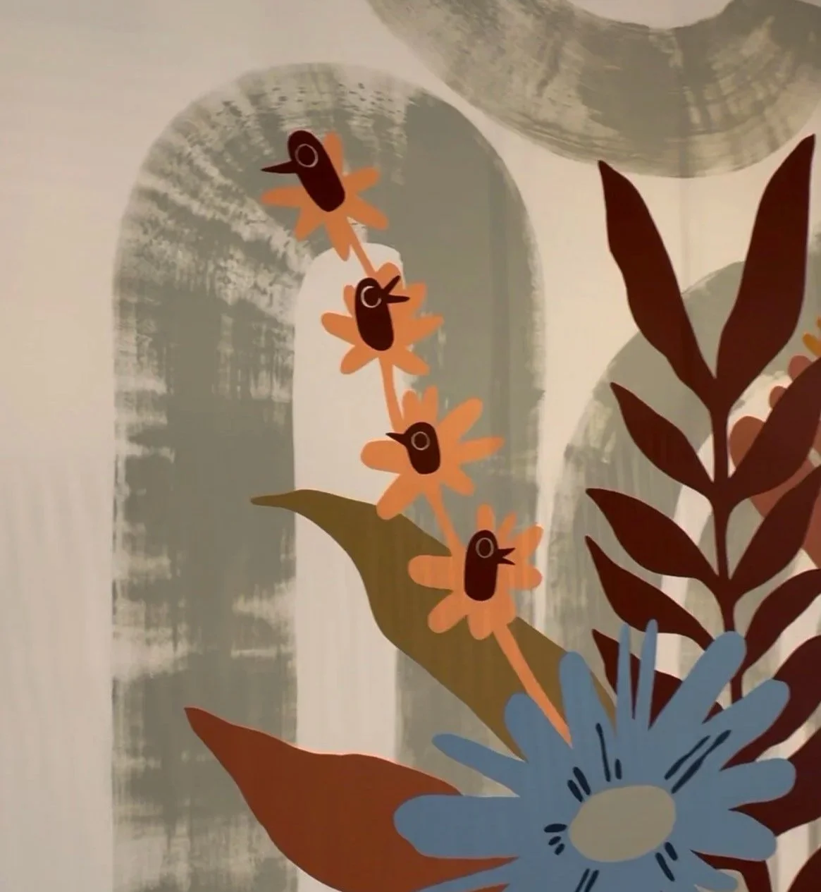 Decorative wall art featuring stylized flowers and birds in earthy tones, with a background of abstract shapes and textures.