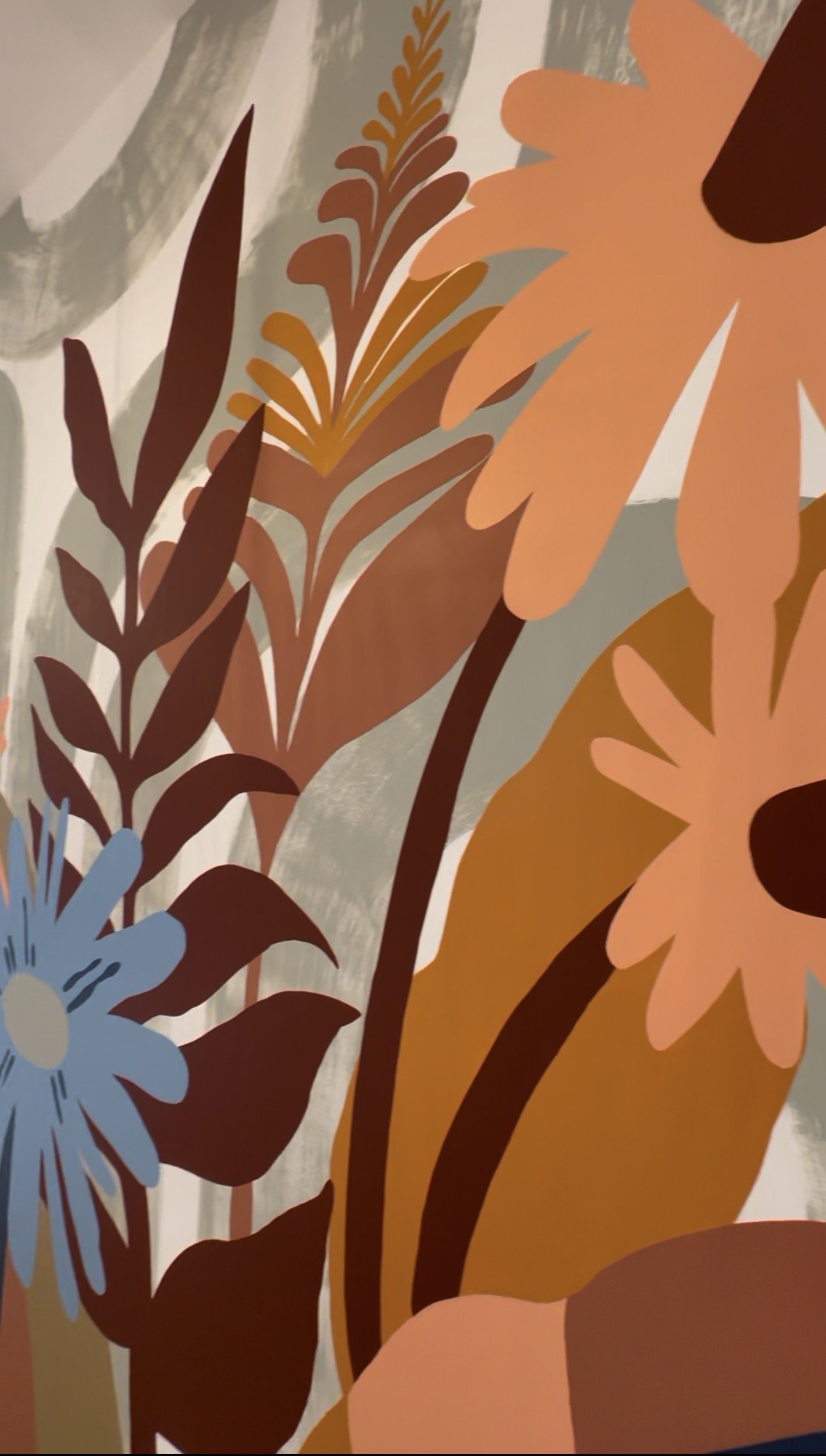 Close-up of a colorful, abstract floral pattern featuring large, stylized flowers and leaves in earthy tones of brown, orange, pink, blue, and beige.