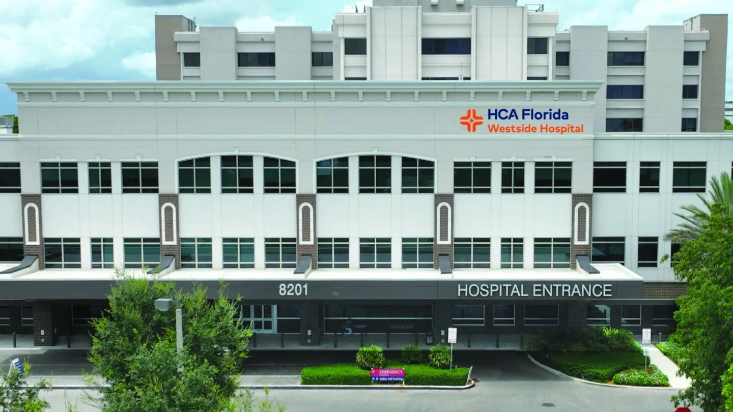 Exterior view of HCA Florida Westside Hospital, a multi-story medical building with the hospital's sign and entrance labeled.