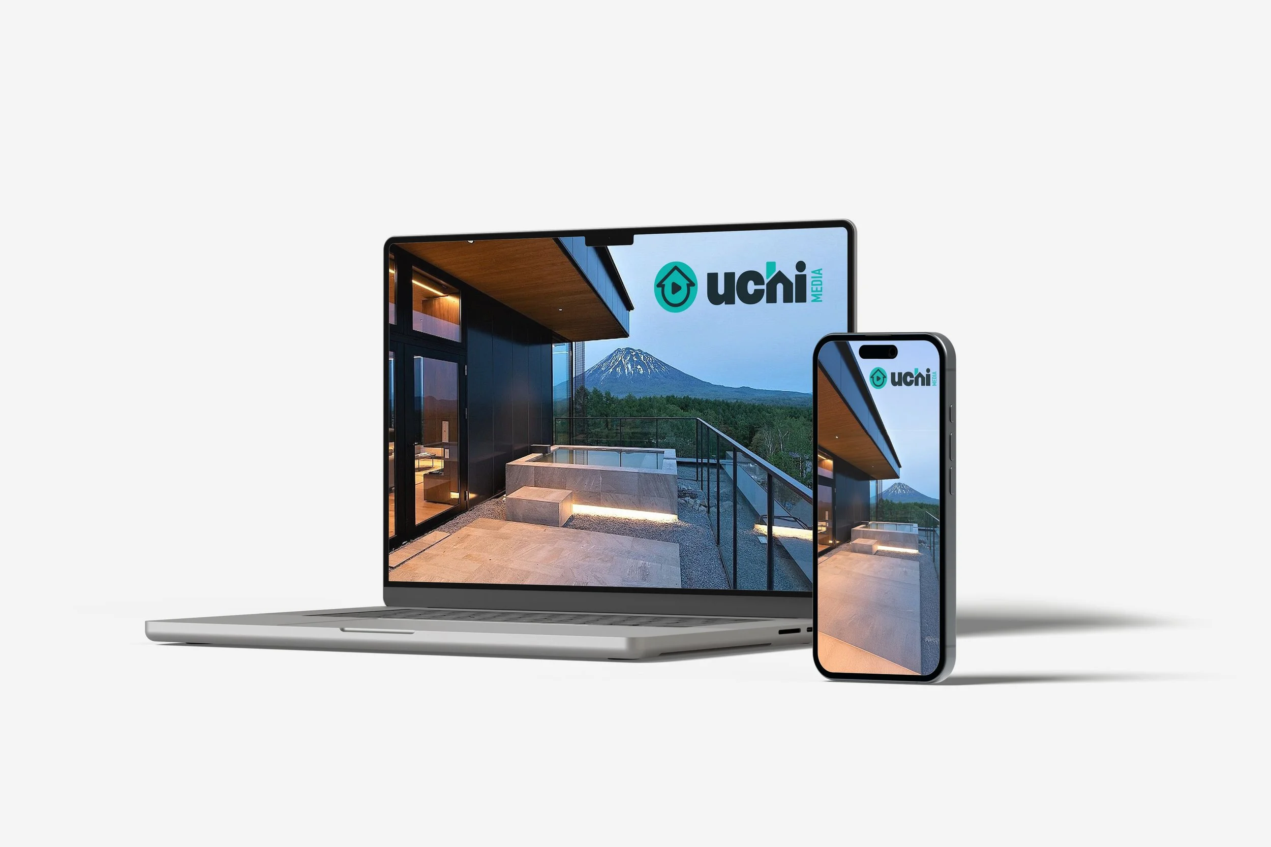 Laptop and smartphone displaying the same outdoor scene of a modern balcony with a mountain and a tree in the background, with the 'uchi media' logo on the screens