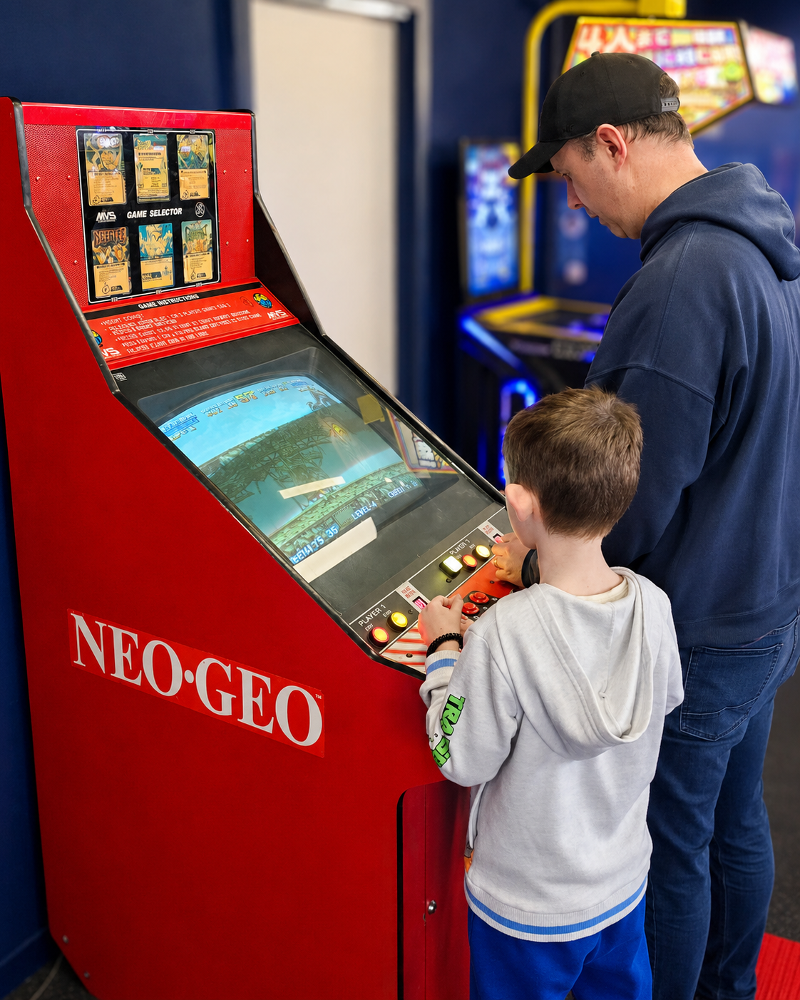 2 people playing and old school arcade game made by SNK - NEO-GEO