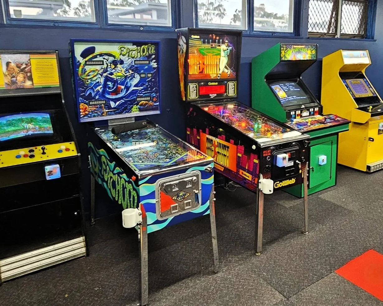 picture of arcade machines at our location, DropBear HQ.  Fathom Revisited Pinball, Big Hurt Pinball, TMNT Arcade, Simpsons arcade & Willow arcade