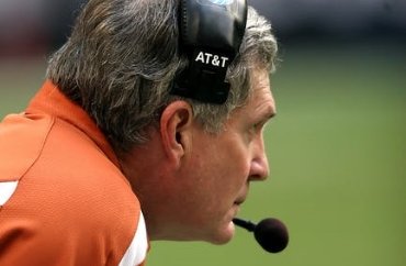Close-up of a man wearing an AT&T headset with a microphone, outdoors in sunny weather.