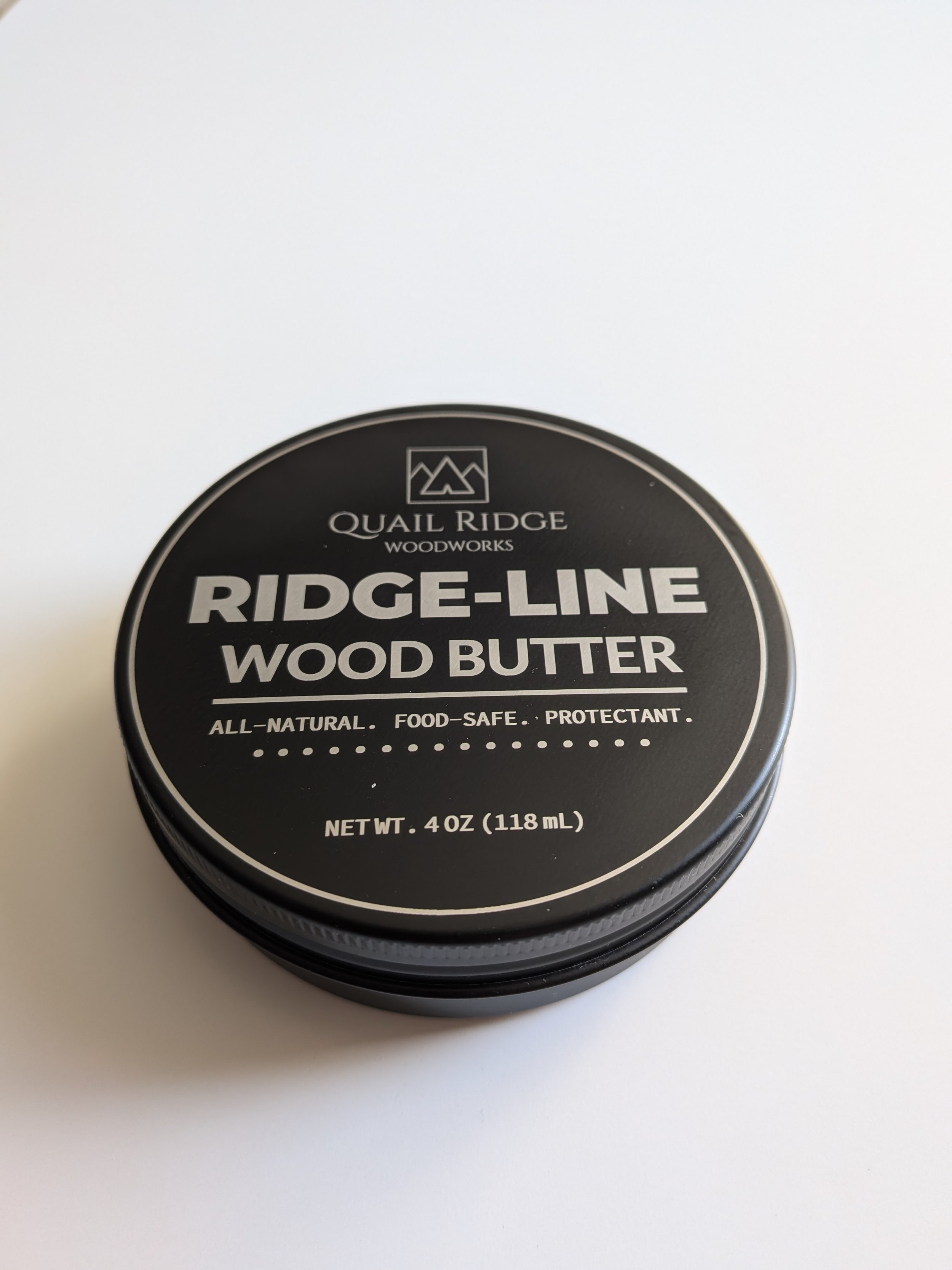 4-ounce Ridge-Line Wood Butter tin with product label