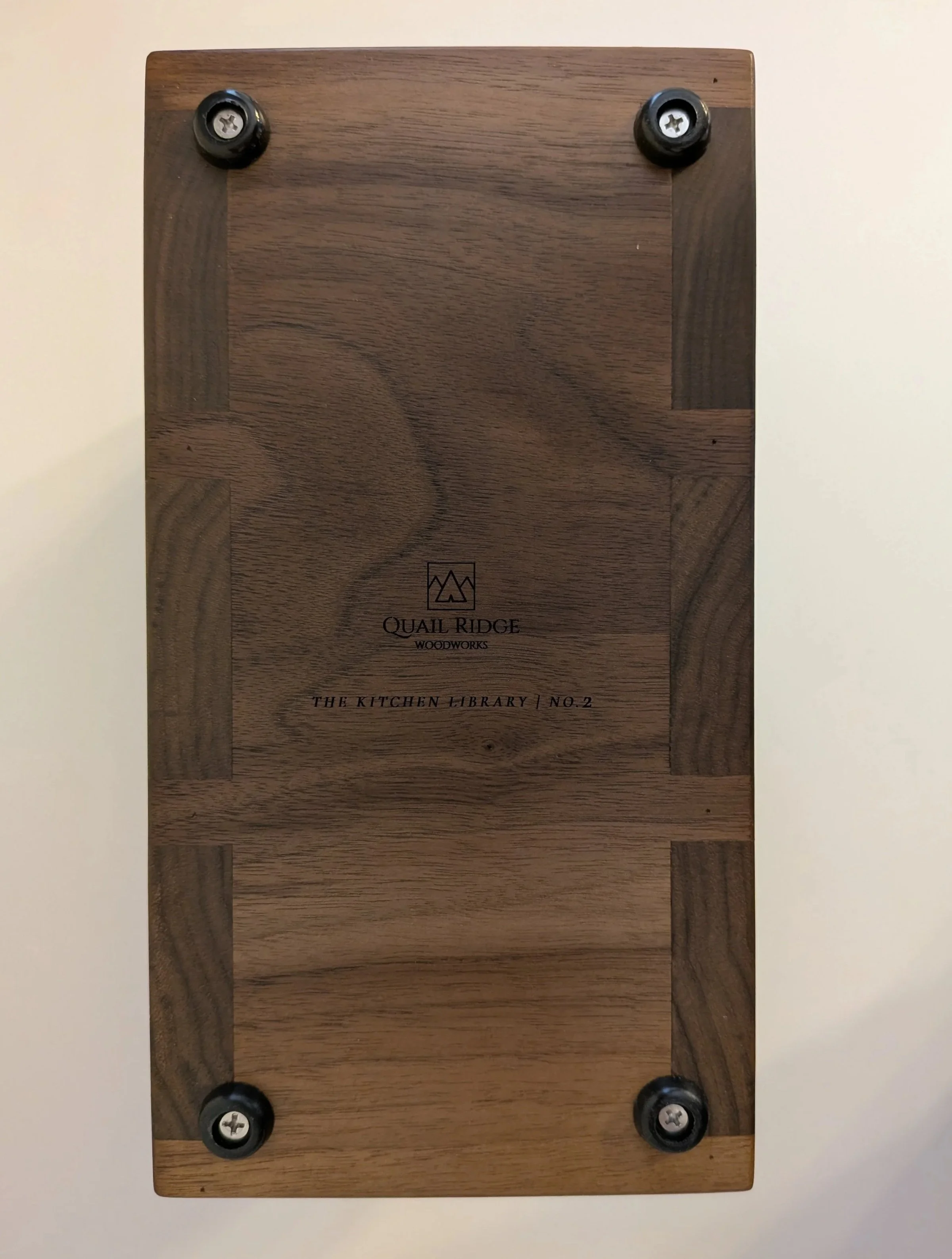 Bottom view of walnut cutting board stand showing construction