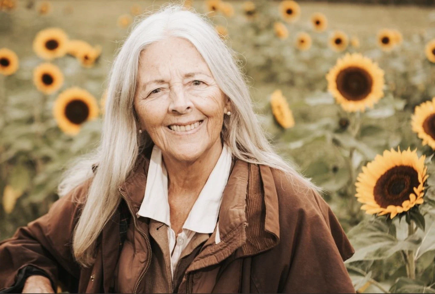 Helena Norberg-Hodge in field of sunflowers