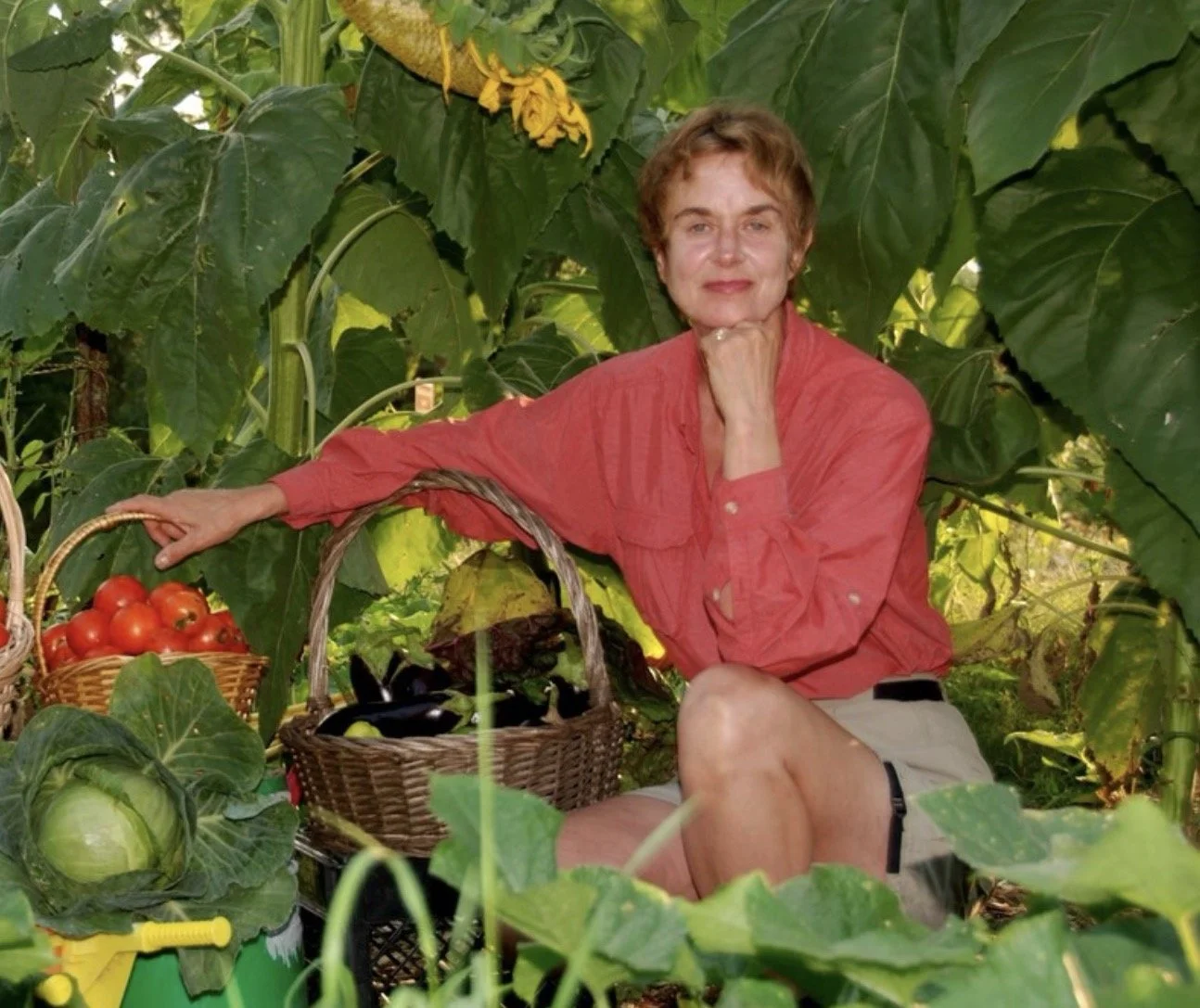Woman in a lush garden with homegrown vegetables