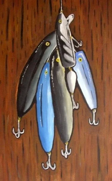 A fishing lure designed to look like a fish with multiple hooks hanging from it, placed against a wooden background.
