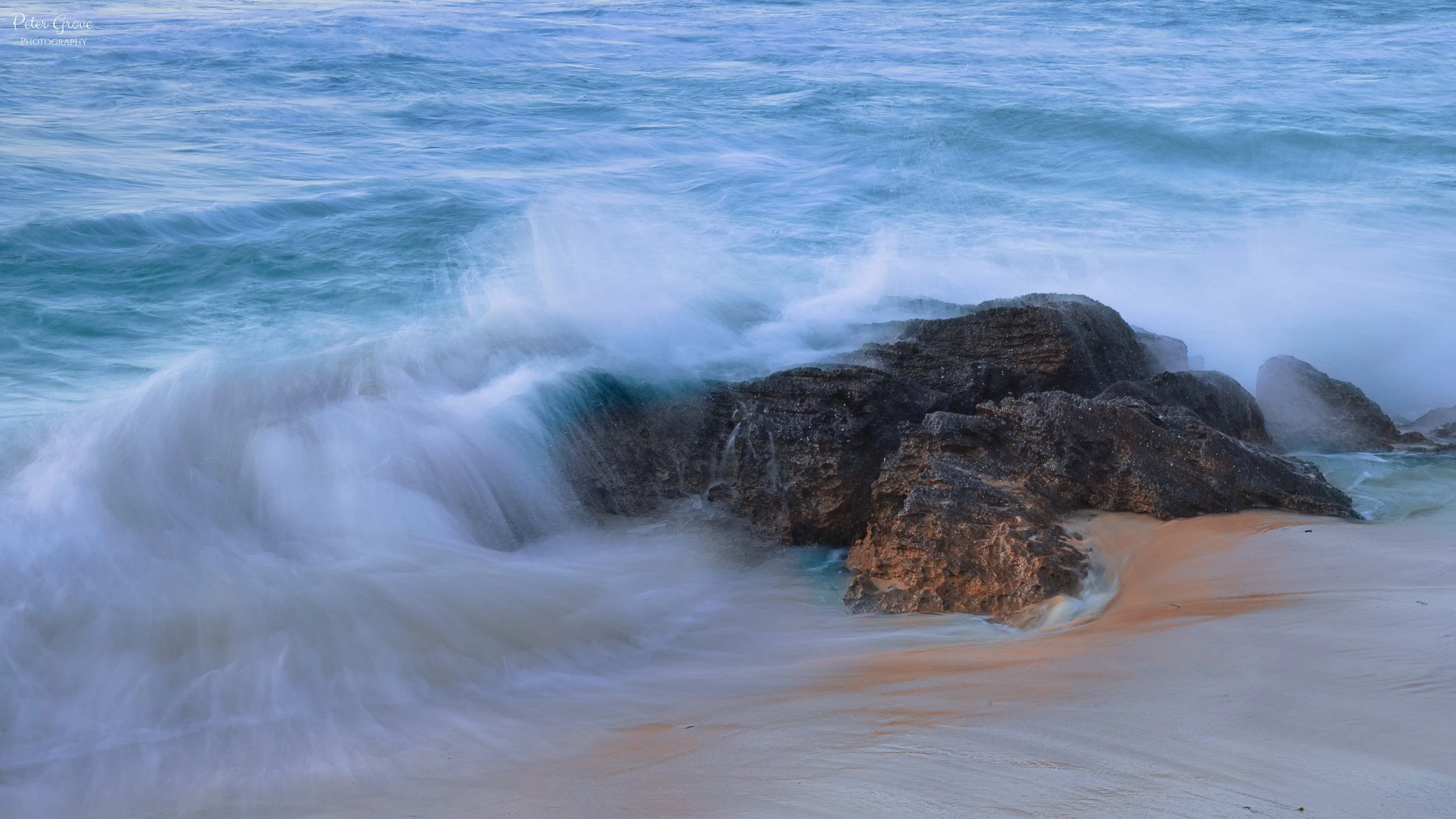 Waves crashing on a rock