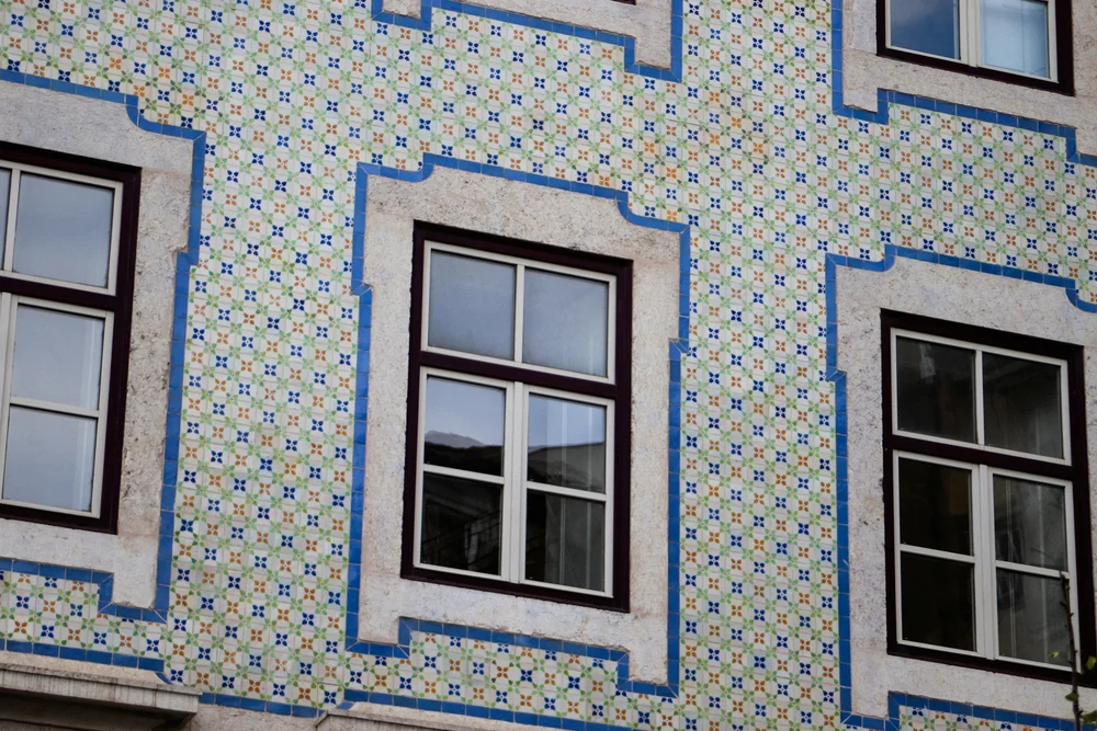 Patterned Portuguese tiles and windows on a building facade