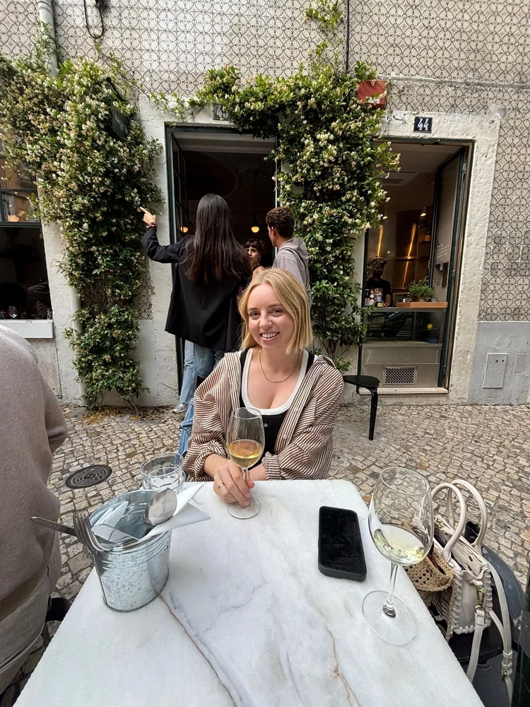 Kate Burgess, Meta ads specialist at Slow Pour Marketing, sitting at a café table